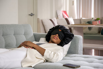 Image of sleeping lady wearing head cover with eye mask